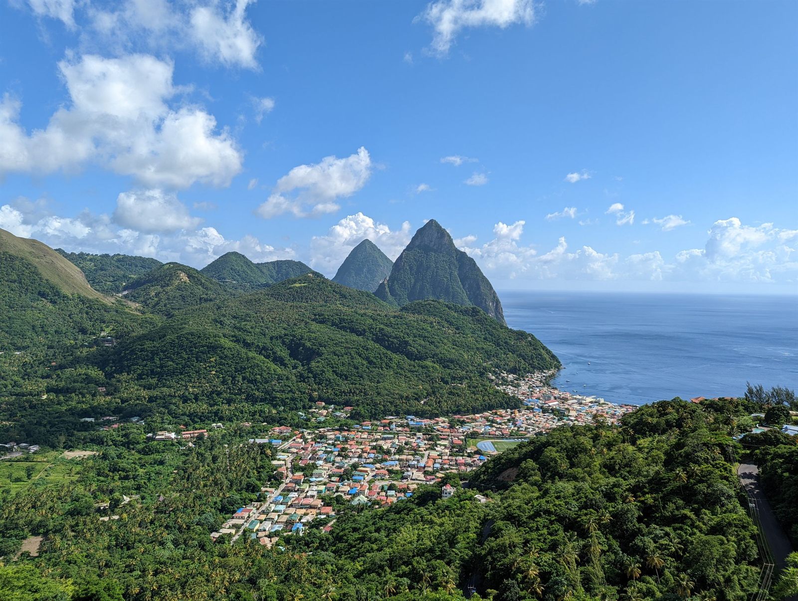 Green hills and the Pitons rising above a town on St. Lucia